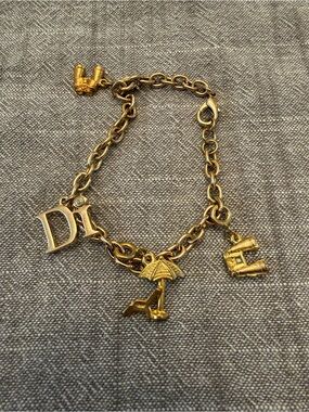 Gold Charm Bracelet with Umbrella Charms and binocular charms.